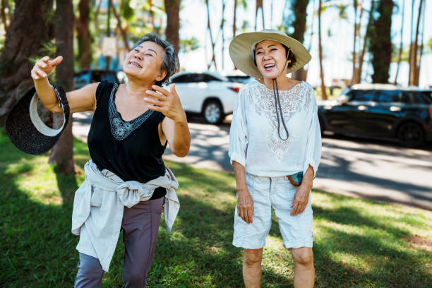 istock Playful senior women laughing while on a walk in a park 1871557727