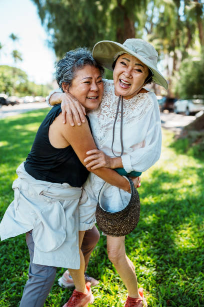 istock Two senior Korean women laugh and affectionately embrace 1871557738
