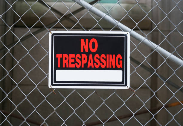 istock no trespassing warning sign on iron chainlink fence 1871559829