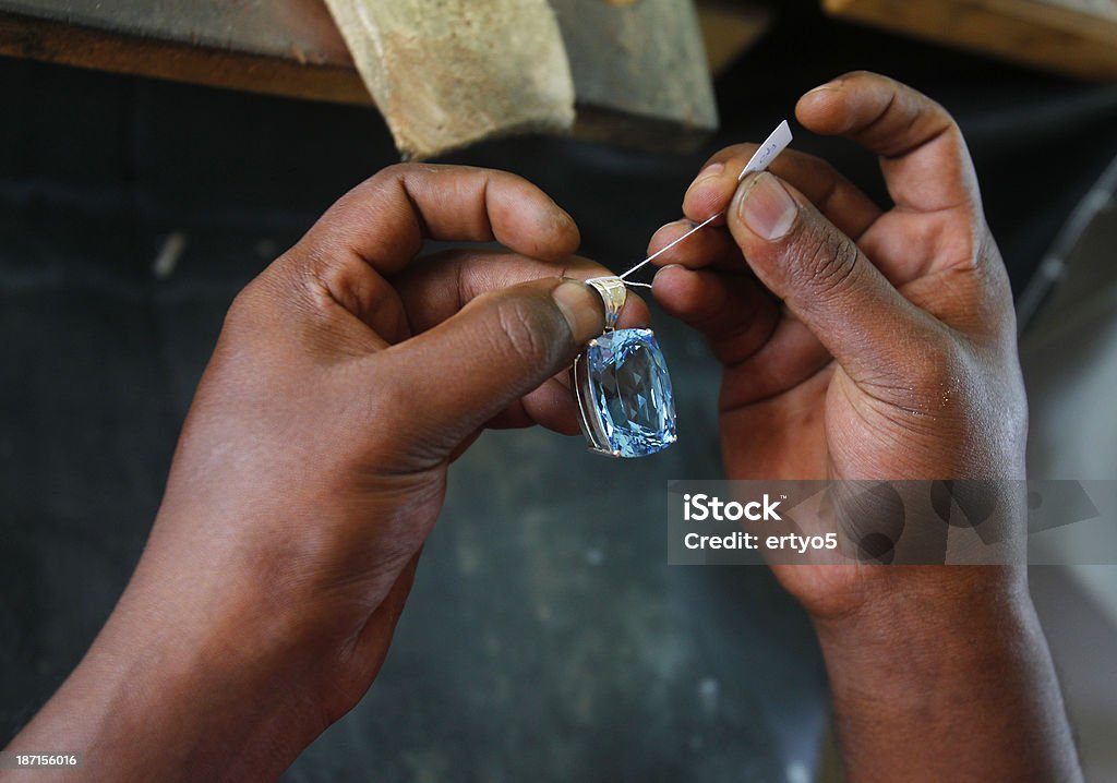 Sri Lankan store worker prepares a gem Sri Lankan store worker prepares  a gem in a  store Gemstone Stock Photo