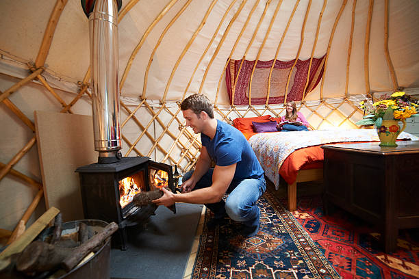 Couple Enjoying Luxury Camping Holiday In Yurt Rising popularity of glamping - glamorous camping yurt photos stock pictures, royalty-free photos & images