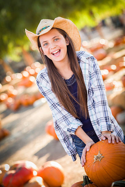 istock Happy Girl Playing at the Pumpkin Patch 187156839