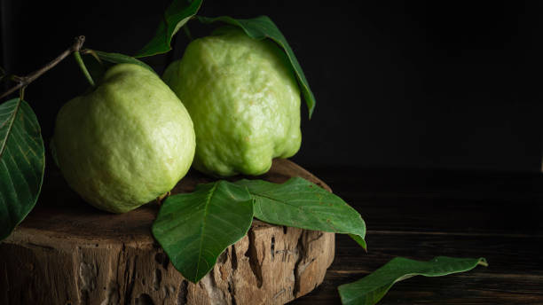 istock Bright green guava with leaves on a cutting board 1871579760