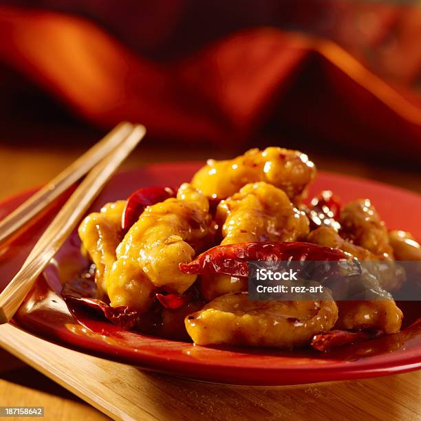 Closeup Of General Tso Chicken Dish On Red With Chopsticks Stock Photo - Download Image Now