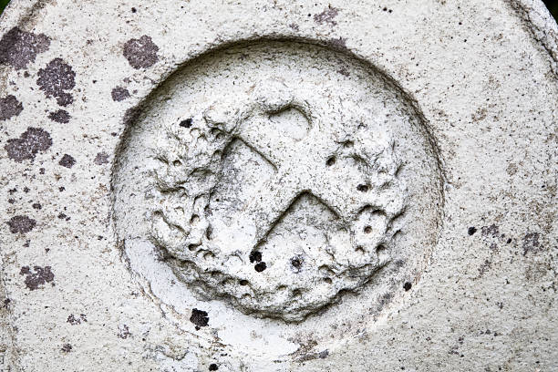 istock Cross in wreath on a 19th century white granite tombstone 187158789