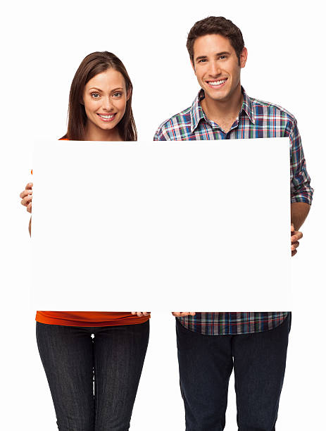 istock Young Couple Holding Blank Sign - Isolated 187159242
