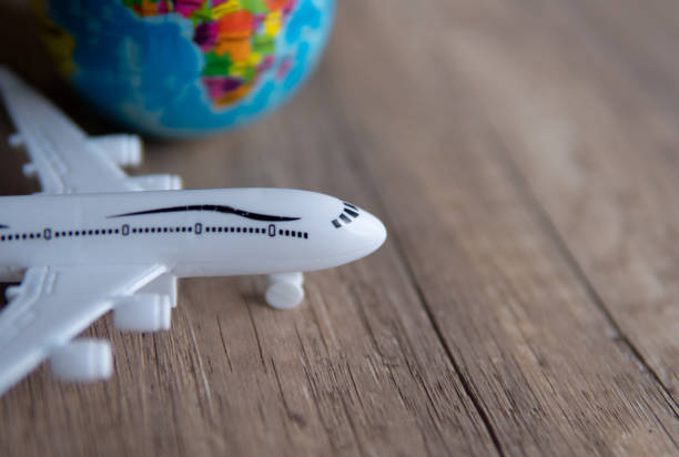 istock Closeup image of toy plane and earth globe on table with copy space. 1871607198