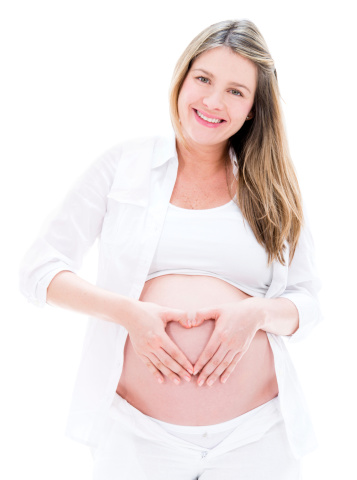 Loving pregnant woman making a heart shape - isolated over white