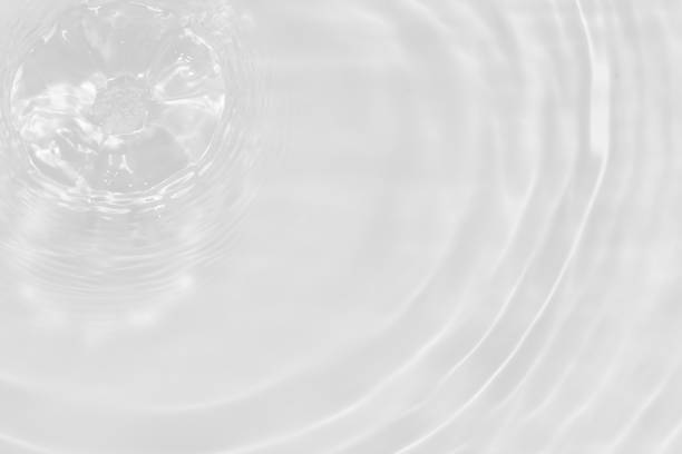 istock White water with ripples on the surface. Defocus blurred transparent white colored clear calm water surface texture with splashes and bubbles. Water waves with shining pattern texture background. 1871614000