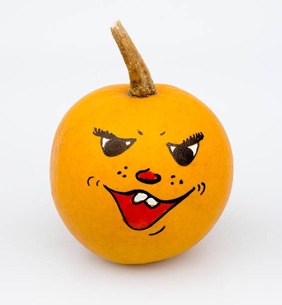 Orange colored pumpkin with painted grimace for halloween isolated on white.