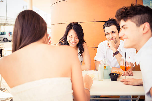 Four friends having aperitif stock photo