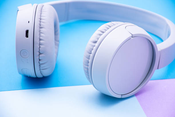 istock Close-up wireless headphones isolated on a blue background. 1871642553