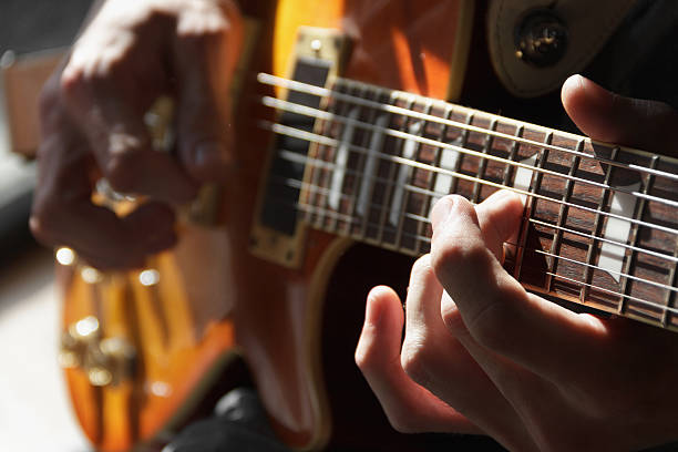 istock Close up of hands playing an electric guitar 187164380