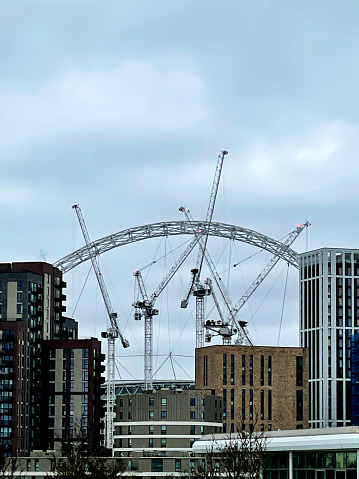 Cranes in front of the Wembley Stadium arch in Wembley, London