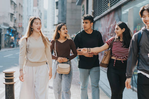 A group of tourists with different nationalities talking to each other while walking