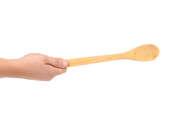 istock Hand holds wooden spoon. 187166590