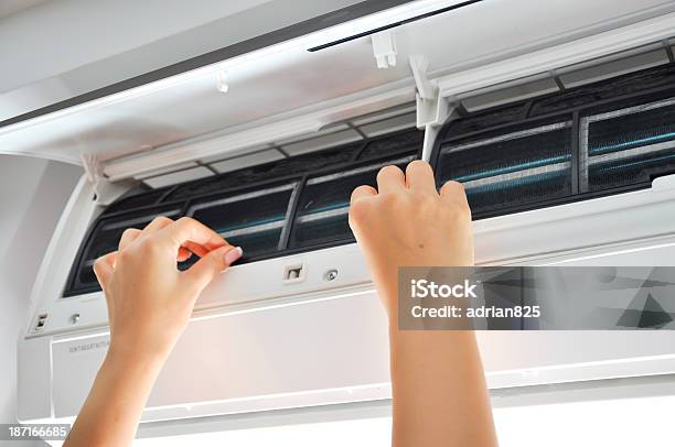 A Woman Cleaning The Filter Of An Air Conditioner Stock Photo - Download Image Now - Air Conditioner, Air Purifier, Backgrounds