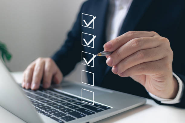 istock Business performance checklist concept, businessman using laptop doing online checklist survey, filling out digital form checklist. 1871668797