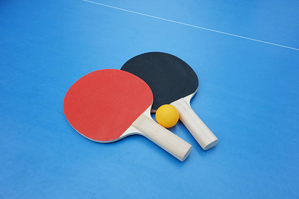 istock Ping pong paddles on a blue tabletennis table 187166936