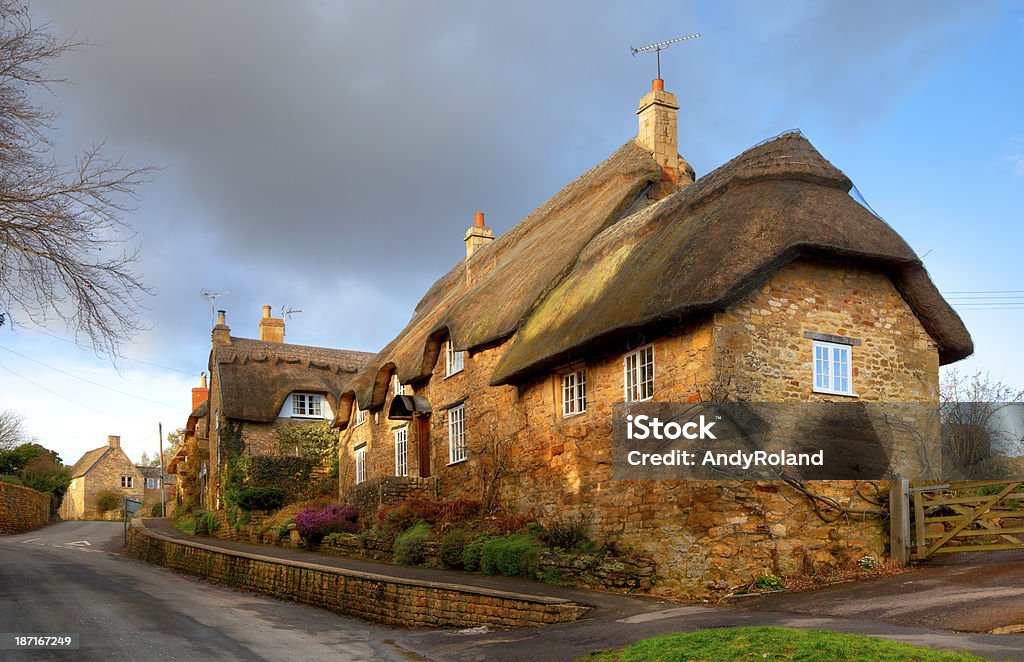 Thatched stone cottage, England Cotwold thatched stone cottage, Ebrington, Gloucestershire, England. Chipping Campden Stock Photo