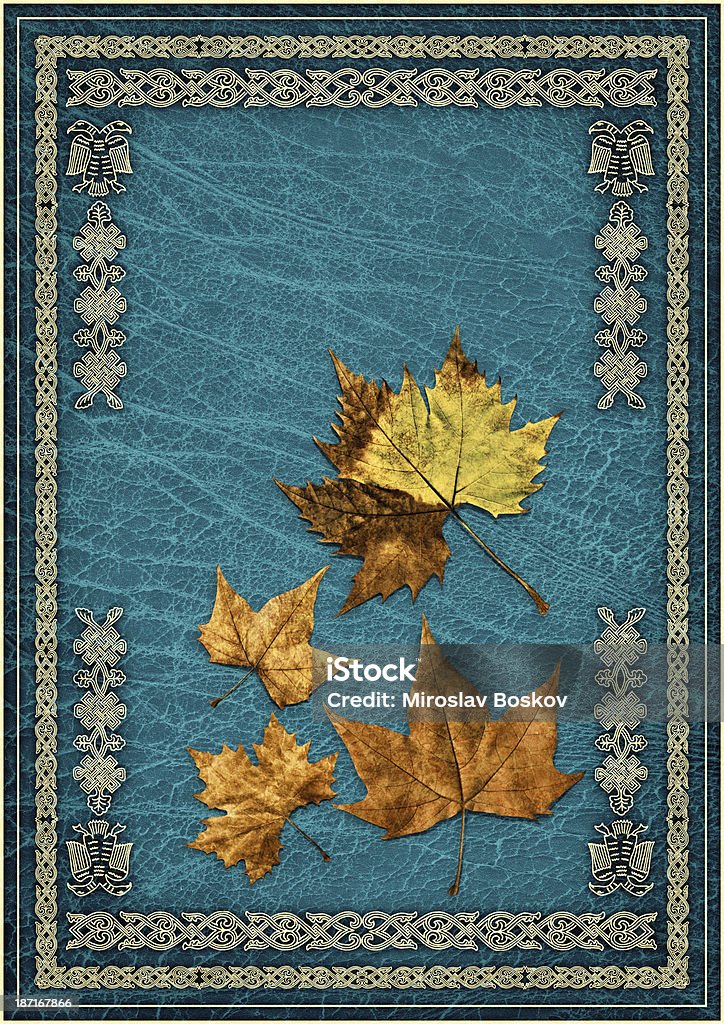 Dry Maple Leaves Isolated on Blue Ornate Gilded Parchment Background This Hi-Res Image of Autumn Dry Maple Leaves set on Emerald Blue Parchment Vignette Grunge Texture, Decorated with Medieval Arabesque Gilded Filigree Linear Pattern, represents the excellent choice for implementation in various CG design projects.  Aging Process Stock Photo