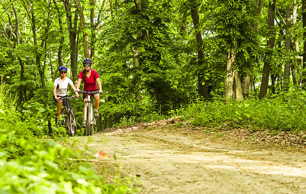 istock girls  biking in the forest 187168260