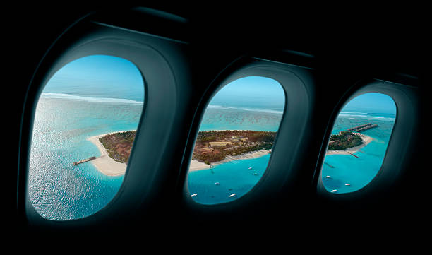istock Tropical island in airplane windows 187168529