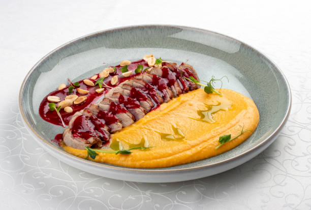 istock Duck breast, with pumpkin puree, cherry sauce and peanuts. Isolated image 1871685672