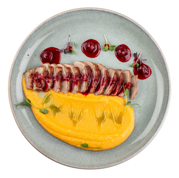 istock Duck breast, with pumpkin puree, cherry sauce and peanuts. Isolated image 1871686186