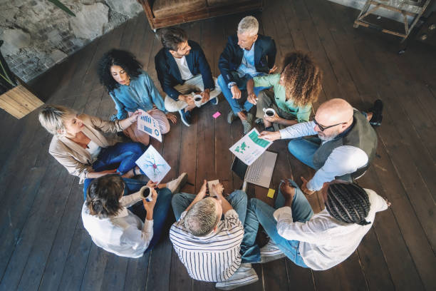 istock Multi-ethnic Team Brainstorming on Rustic Wooden Floor 1871687224