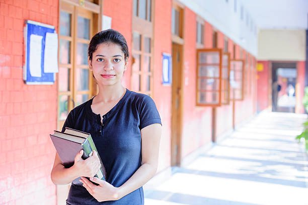 istock A student holds her books at school 187168733