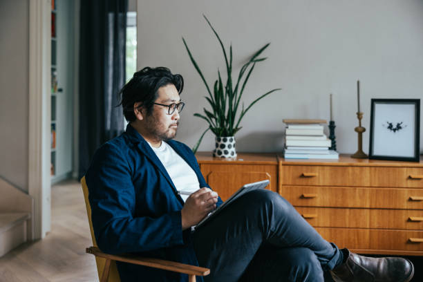 istock Japanese therapist taking notes from therapy session with patient 1871689342