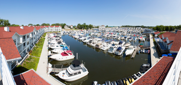 A panoramic scene of New Buffalo Harbour on a clear sunny day. The photograph was taken from an elevated angle and shows moored boats and surrounding area. 