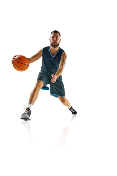 istock Dynamic shot capturing skilled basketball player in action, focused and determined during intense training session against white background. 1871696658
