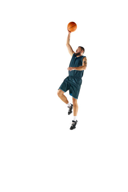 istock Powerful moment frozen in time, professional basketball player commitment to perfect slam dunk against white background. 1871696666