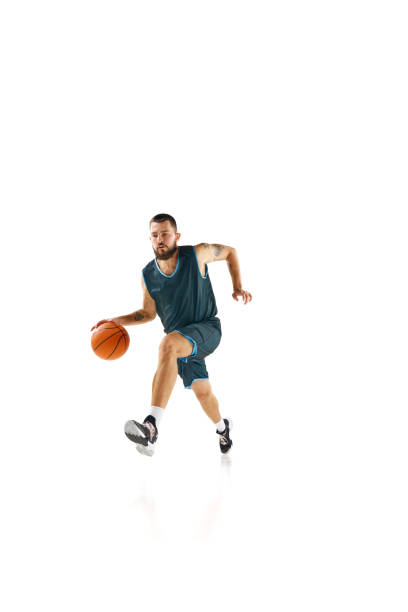 istock Powerful moment frozen in time, basketball player commitment to perfect slam dunk against white background. 1871696669