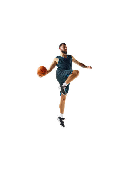 istock Basketball player in uniform demonstrates strength and focus during workout against pristine white background. 1871696672