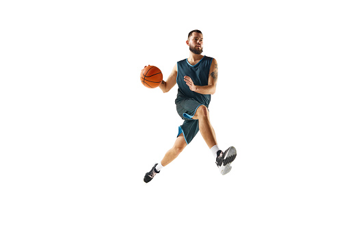 athleticism of basketball player in uniform, engaged in rigorous training routine before championship against white background. Concept of sport, hobby, active lifestyle, power and strength. Ad
