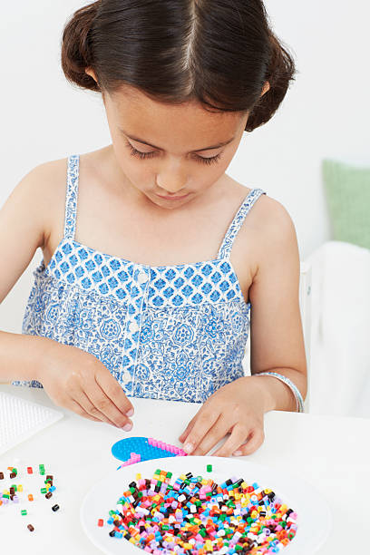 Engaging and enjoyable childrens craft activity that involves colorful beads and imaginative creative designs
