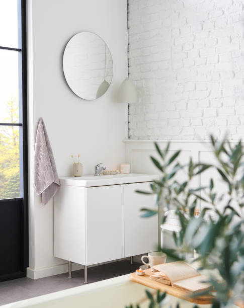 istock White bathroom, interior concept, cabinet, sink, mirror, accessory and plant, decorative style. 1871734963
