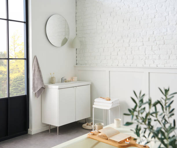 istock White bathroom, interior concept, cabinet, sink, mirror, accessory and plant, decorative style. 1871734964