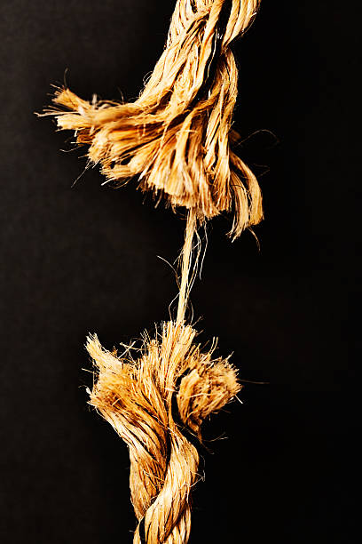 istock Any minute now. Breaking point! Frayed rope about to snap. 187174664