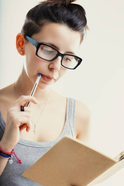istock Intellectual engagement, notebook and pen in hand 1871747194
