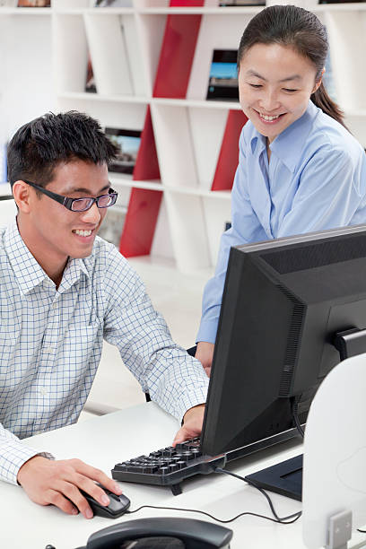 istock Happy coworkers working on their computer in the office 187175342