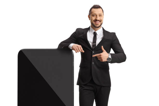 istock Young professional man standing next to a big smartphone and pointing 1871765392