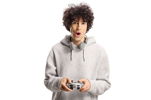 Excited young man playing a video game with joystick isolated on white background
