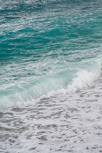 Sea waves crash against stones in beautiful white splashes. Seascape. Panoramic view of the seashore
