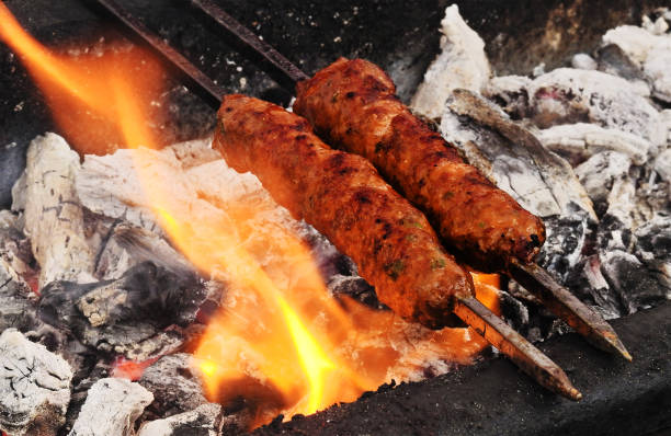 istock view of making mutton kababs or kebabs on coal fired arrangement 1871800619