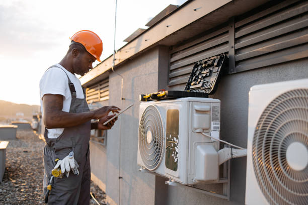 istock Male holding tablet and installing cooling system outdoors 1871802312