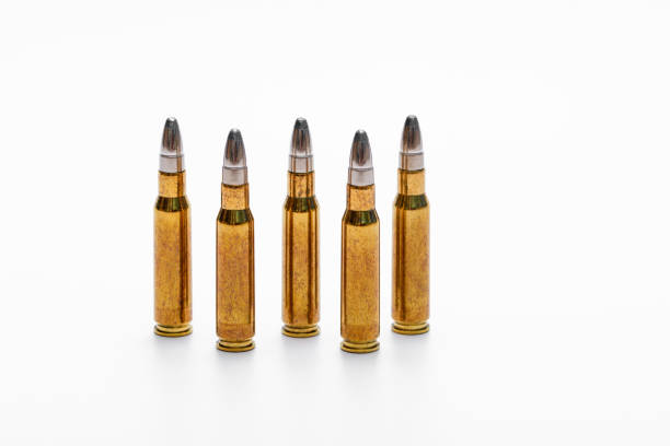 istock Hunting ammunition stands in a row on a white background, golden bullets 1871810846